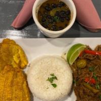 Ropa Vieja · Cuba-style Shredded beef and vegetables that resemble a heap of colorful rags, accompanied w...