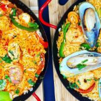 Chicken Paella · Authentic Spanish rice dish studded with chicken and chef's secret ingredients. Serves 2 gue...