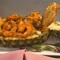 Pineapple Bowl Rice Stew · Consists of beef or shrimp Caribbean stew, served in a fresh pineapple bowl with arroz con g...