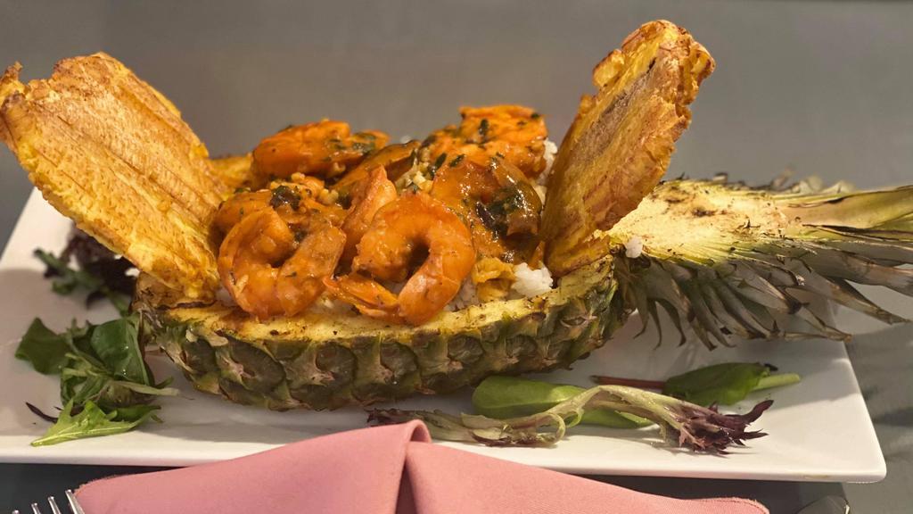Pineapple Bowl Rice Stew · Consists of beef or shrimp Caribbean stew, served in a fresh pineapple bowl with arroz con gandules.