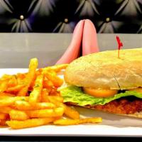Chicken Milanesa Sandwich · Argentinian style breaded chicken breast served on a bread with lettuce, tomato and mayo.