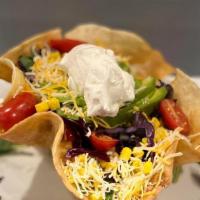 Taco Salad · large crispy flour tortilla shell filled with Romaine lettuce, mixed with tomatoes, red onio...