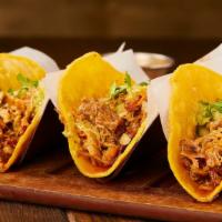 Carnitas Taco · Savory slow cooked shredded pork shoulder. Topped with onions, cilantro, and spicy tomatillo...