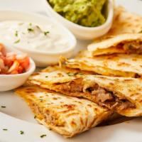 Carnitas Quesadilla · Flour tortilla filled with savory slow cooked shredded pork shoulder and cheese. Topped with...