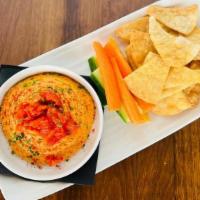 Hummus Plate · Roasted red pepper hummus served with seasoned pita chips & seasonal raw veggies