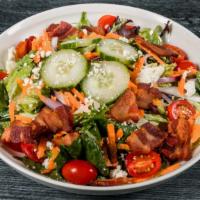 Chophouse Salad · Crisp romaine & field greens, bacon, tomato, blue cheese, cucumber, carrot &  red onion, tos...