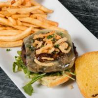 Signature Tavern Burger · Flame-grilled seasoned patty with aged cheddar cheese, arugula, truffle garlic aioli, onion ...