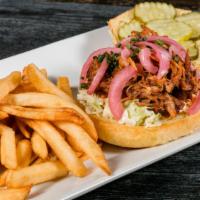 Pulled Pork Sandwich · Slow roasted pulled pork w/ bbq sauce, topped with coleslaw, pickled red onion & onion strings