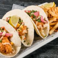 Baja Fish Tacos · Lightly fried cod in 3 flour tortillas with slaw, mango salsa, pickled red onion & chipotle ...