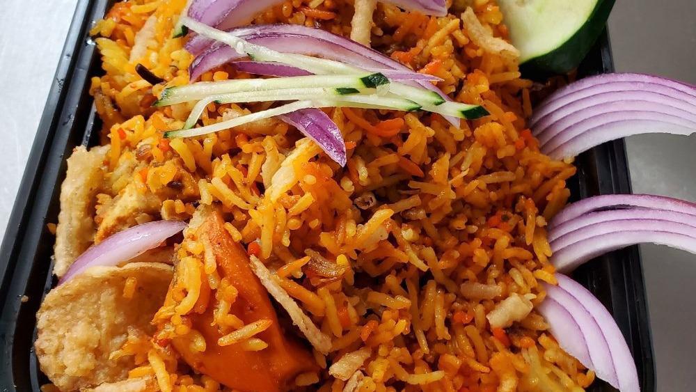 Chicken Tikka Biryani · Marinated chunks of chicken cooked in a clay oven, then mixed with seasoned basmati rice.