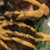 Maryland Crab Cakes · Our signature pan seared crab cakes topped with Cajun aioli & herbs