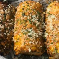 Southern Grilled Corn On The Cob · Grilled corn, tossed in Cajun aioli, lime, Espelette, topped with aged cheese