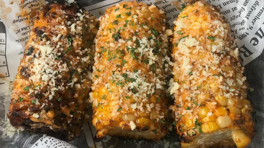 Southern Grilled Corn On The Cob · Grilled corn, tossed in Cajun aioli, lime, Espelette, topped with aged cheese