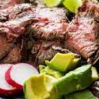 Carne Asada · A tender flank steak with a side of white rice mixed with vegetables and a side of red beans.