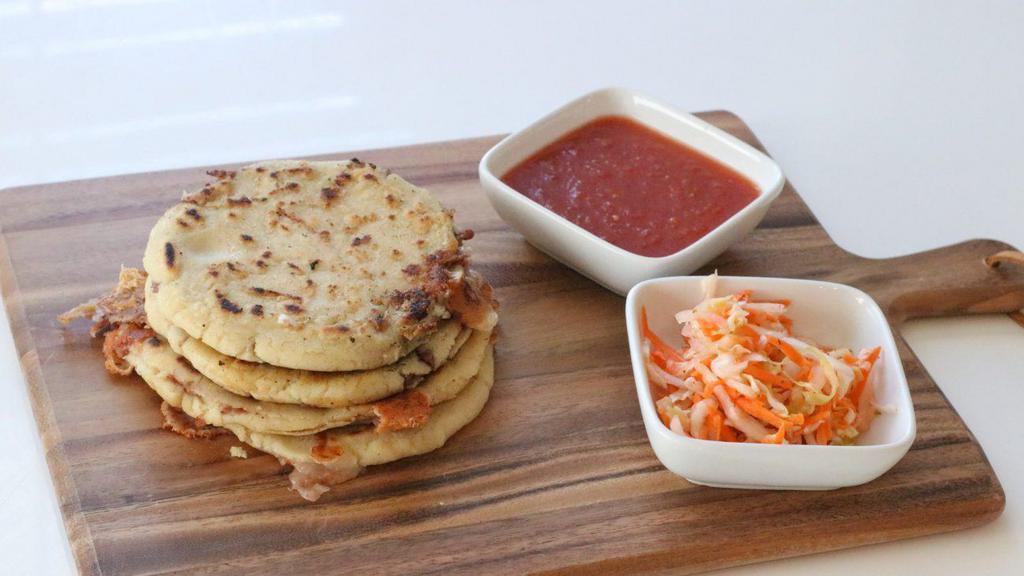 Pupusas · One Pupusas stuffed with cheese ad your choice of pork, beans, loroco, or just cheese. Served with a smalled side of cabbage and a savory tomato sauce.