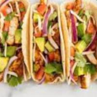 Chicken Tacos · Three grilled chicken tacos in a fresh corn tortilla topped with cilantro. Choose optional t...