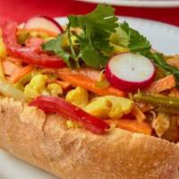 Salvadoran Chicken Sandwich · Hand-pulled chicken breast in a Salvadoran bread, topped with cucumber, tomato, radish, lett...