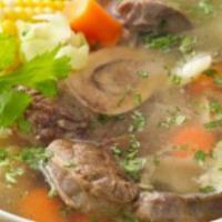 Sopa De Res (Beef Soup) · A hearty beef soup made with beef, yuca root, potatoes, carrots, celery, and corn. Garnished...