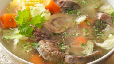 Sopa De Res (Beef Soup) · A hearty beef soup made with beef, yuca root, potatoes, carrots, celery, and corn. Garnished with cilantro.
