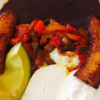 Huevos Rancheros Breakfast · Served with refried beans, avocado, fried sweet plantains, homemade cheese, sour cream and t...