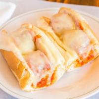 Meatball Parmigiana Sub · Homemade with tomato sauce, provolone cheese, and Romano cheese. On a foot-long sub roll.