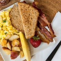 Farmer’S Breakfast · Scrambled eggs, bacon, home fries, sliced fruit, and toast.