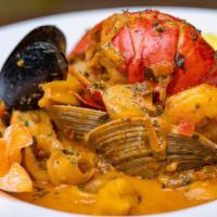 Potaje De Mariscos · Lobster,shrimp,calamaris,clams,mussels and fish in creamy seafood saffron broth.