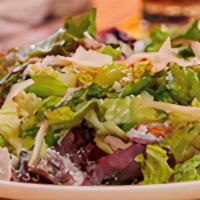 House Salad · Iceberg lettuce, served with tomatoes, onions, & topped  with croutons, served with your cho...