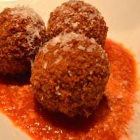 Arancini · Fried risotto balls with marinara sauce.