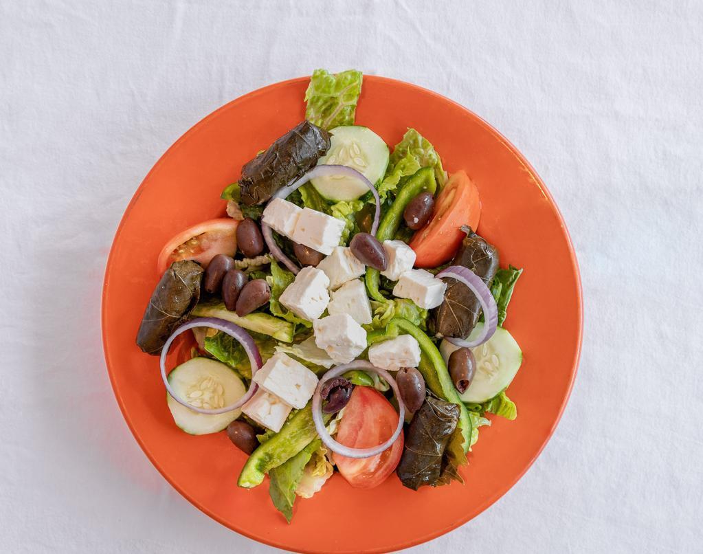 Greek Salad · Feta cheese, black olives, stuffed grape leaves, anchovies and our famous Greek dressing.