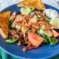 Rams Salad · Lettuce, tomato, cucumber, green pepper, black olives, hard boiled egg and bacon, topped wit...