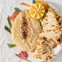 Hummus · Mashed chickpeas blended with tahini and garlic seasoning. (Served with pita or chips)