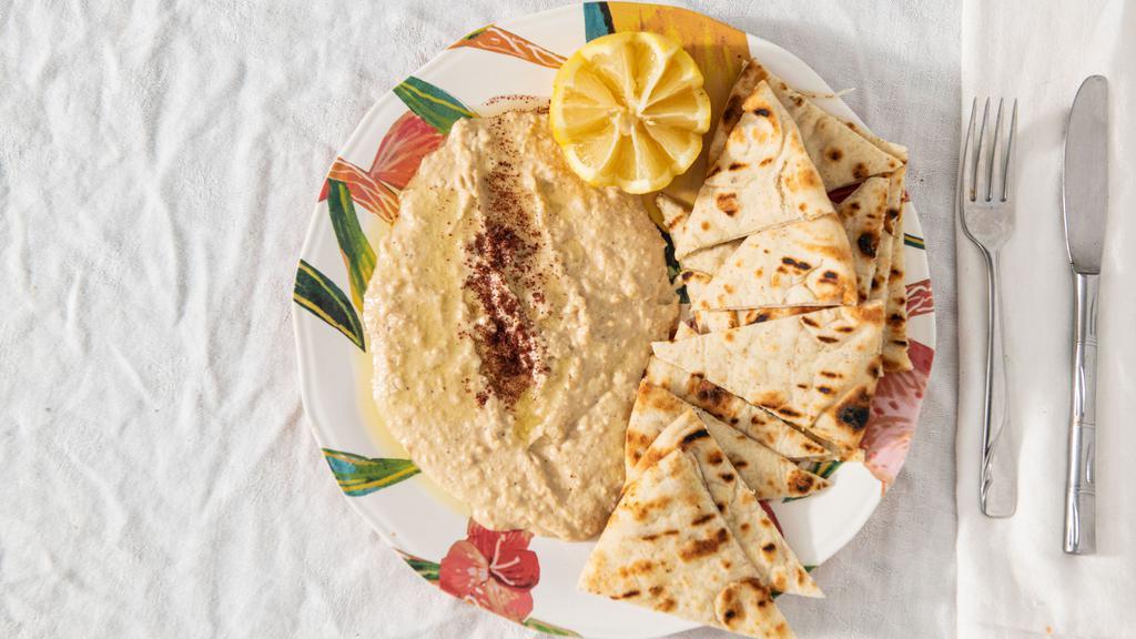 Hummus · Mashed chickpeas blended with tahini and garlic seasoning. (Served with pita or chips)