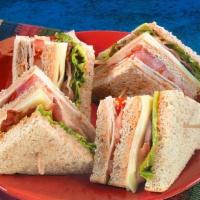 Turkey Club Sandwich · Freshly made with cheese, bacon, lettuce, tomato, and mayonnaise, layered between toasted br...