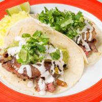 Cabo San Lucas · Grilled steak, grilled poblano pepper + red onion, guacamole, lime crema, cilantro, flour to...