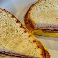 Triple Melt · Smoked turkey, ham and crispy bacon with melted cheese, lettuce, tomato, pickles, 26 aioli a...