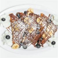 Deluxe French Toast · French toast with Nutella, strawberries, bananas, powdered sugar, and whipped cream.