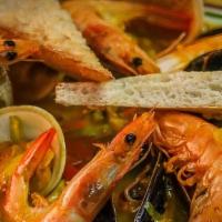 Zarzuela De Mariscos · A shellfish and seafood stew made with seasonal vegetables, shrimp, mussels, calamari, clams...