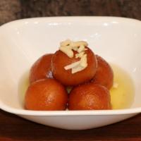 Gulab Jamun · Made with dried milk, shaped into a ball, fried and then soaked in a cardamom based sugar sy...