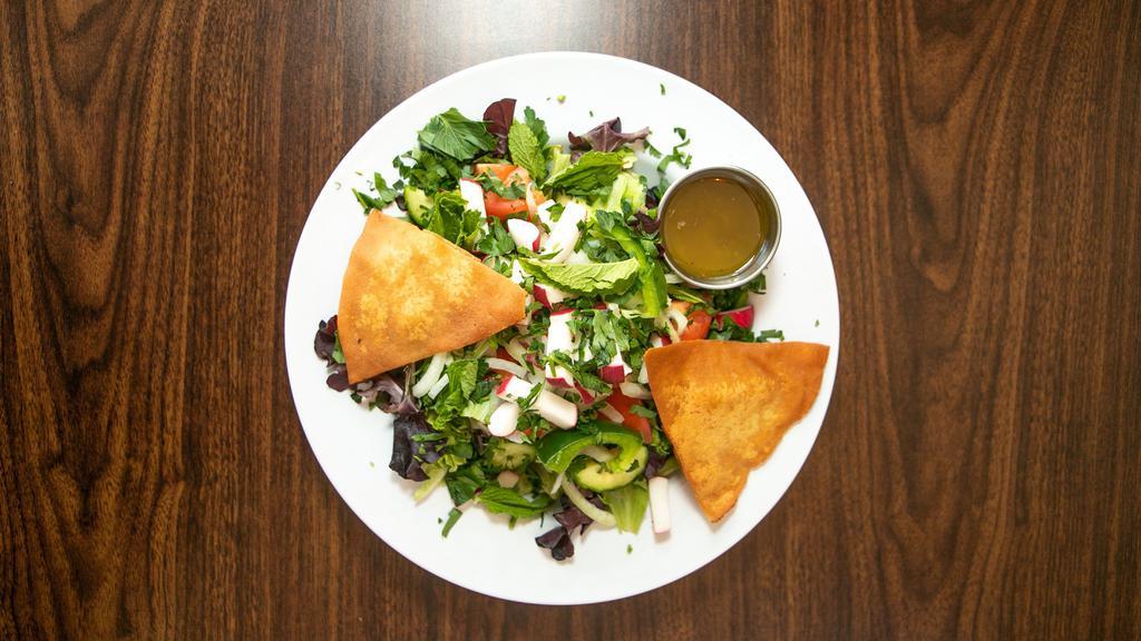Fattoush Salad  · Vegetarian. Mixed greens, cucumbers, tomatoes, onions, radishes, green pepper, mint, parsley with a lemon-garlic dressing, & pita chips. Consuming raw or undercooked meats, poultry, seafood, shellfish, or eggs may increase your risk of foodborne illness. Please advise your server about any food, nuts allergies.