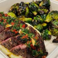 Petit Tender Steak · An 8oz petite tender steak sous vide for 6 hours and seared to perfection. Sliced and topped...