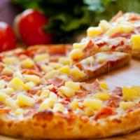 Hawaiian Pizza · Homemade pizza dough is topped handfuls of pineapple, ham, crispy Canadian bacon and cheese.