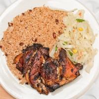 Jerk Chicken · Served with rice and peas and cabbage or white rice.