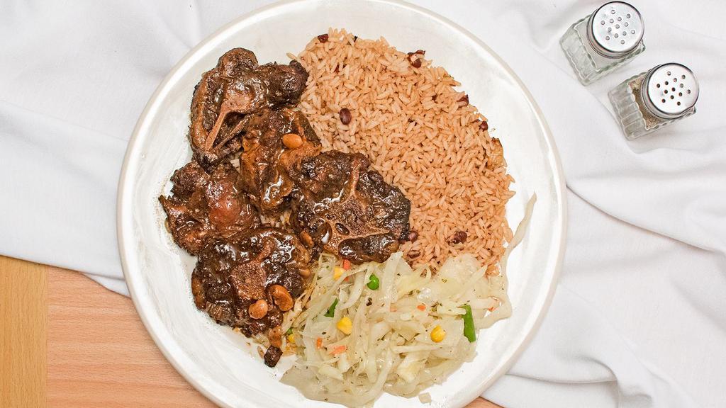 Oxtail · Served with rice and peas and cabbage or white rice.