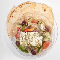Greek Horiatiki Salad · With tomatoes, cucumbers, red onions, green peppers, Kalamata olives, feta cheese, and extra...