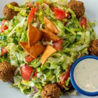 Jerusalem Style Salad · Vegetarian. Romaine lettuce, diced tomatoes, cucumbers, falafel and our homemade pita chips.
