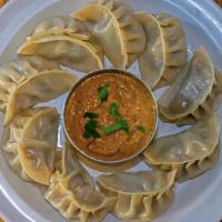 Chicken Momos · Classic dumplings steamed or pan-seared. Served with our secret momo sauce.