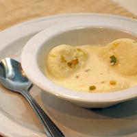 Ras Malai · Light and fluffy cakes of ricotta-like cheese soaked in a sweet milky syrup.