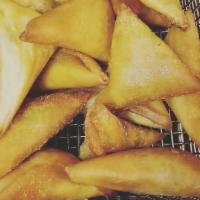 Samosas · Fried pastry with hearty vegetable or minced meat filling.