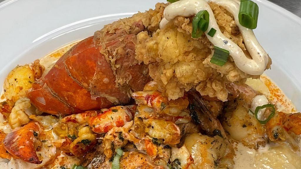 Seafood Salmon · Blackened salmon with sautéed shrimp, jumbo lump crab and lobster claw meat over spinach and your choice of mashed potatoes or grits all with cajun cream drizzle